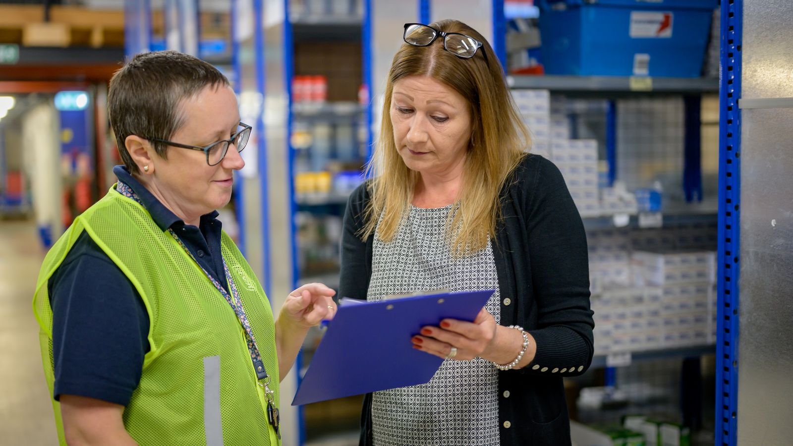professional commercial cleaner holding clipboard in office