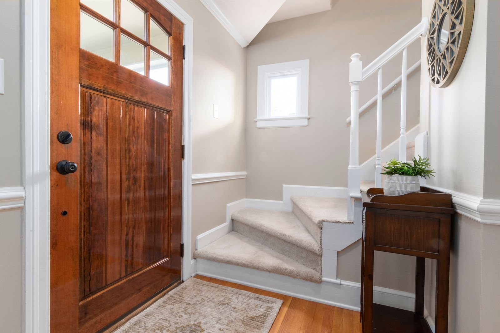 Carpeted staircase and entrance mat at a Manchester home front door Carpeted staircase and entrance mat at a Manchester home front door