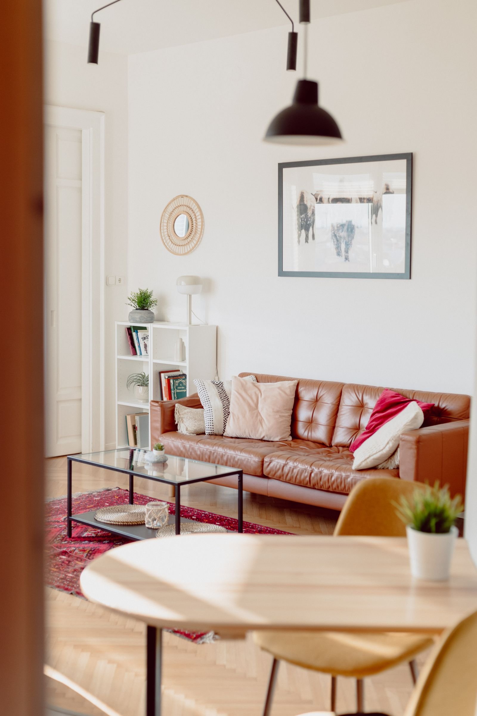A tan leather sofa in a bright living room