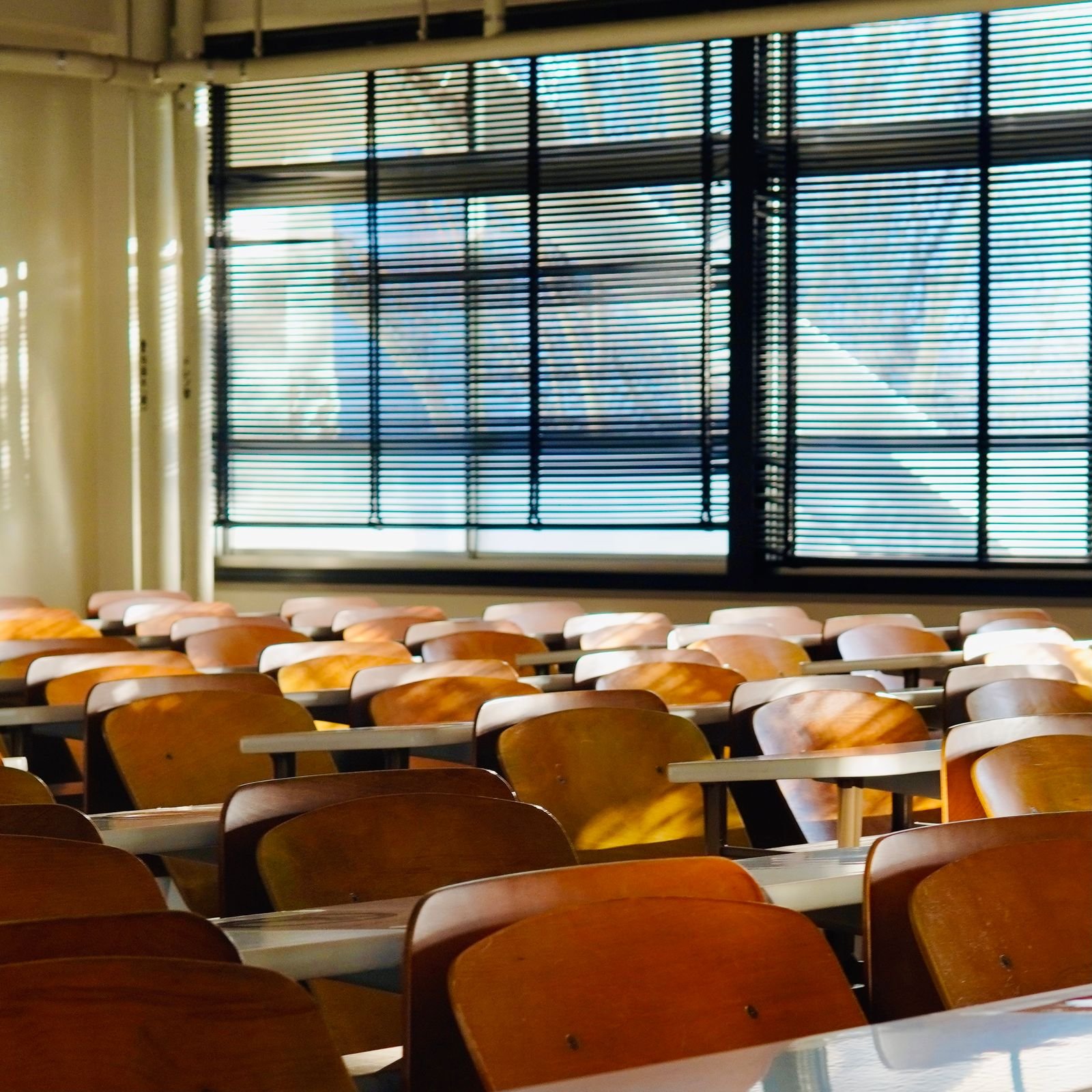 Summer Holiday Deep Cleans for Manchester Schools and Nurseries An empty sunlit classroom with rows of desks