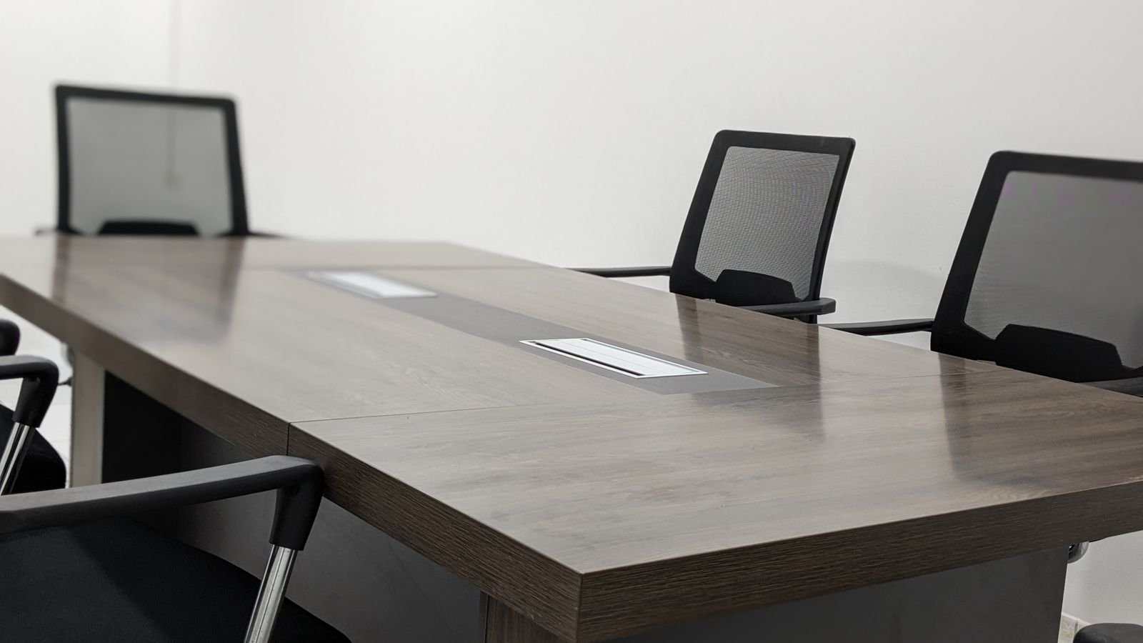 Empty office meeting room with a wooden table and black chairs. Empty office meeting room with a wooden table and black chairs.
