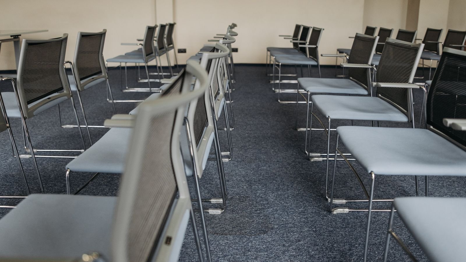 Rows of empty meeting chairs on a grey commercial carpet. Rows of empty meeting chairs on a grey commercial carpet.